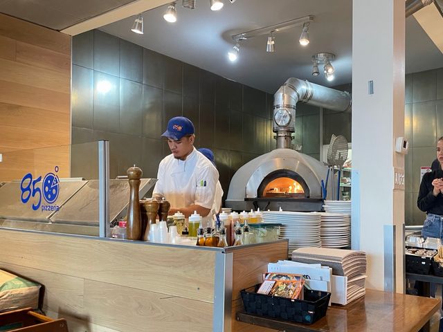 The wood-fired brick oven and pizza station