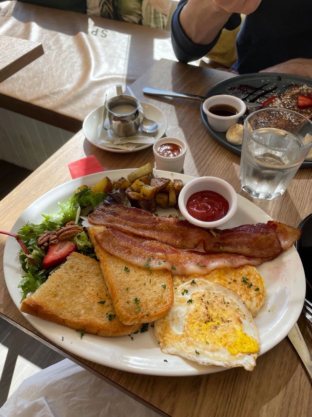 Long Brunch with bacon, fried eggs, potatoes and toast